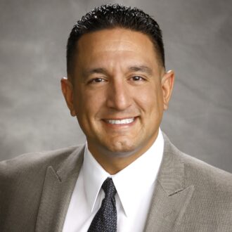 Man wearing a tie and smiling